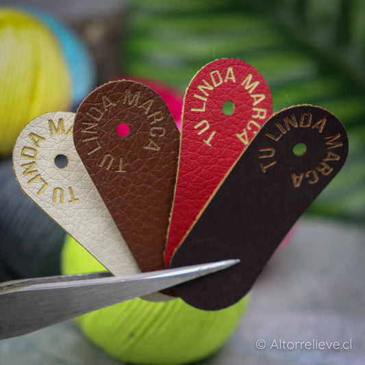 100 Etiquetas EcoCuero Remache Plegada 5x2cm